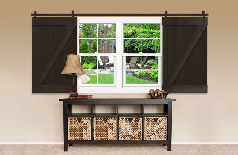 Dark brown barn door shutters on a window 